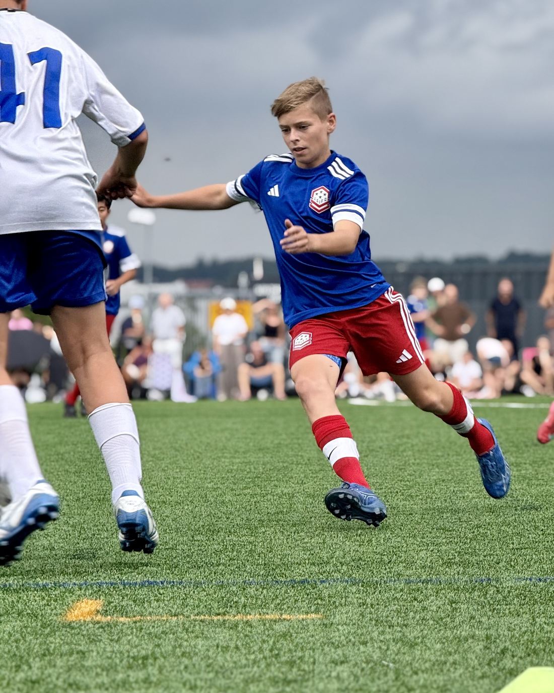 USIFC players in blue and red battle for the ball